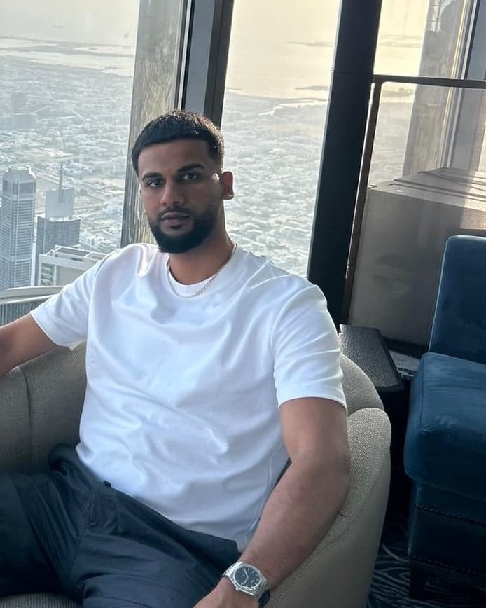 Niral Joshi, seated by a window overlooking a city skyline